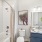 bathroom with blue cabinets and plant on the counter