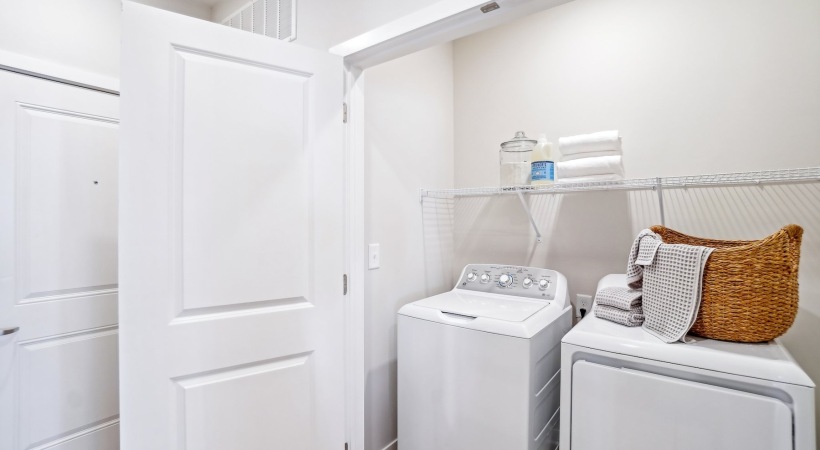 Everything you need right at your fingertips laundry cloest with shelving and a woven basket