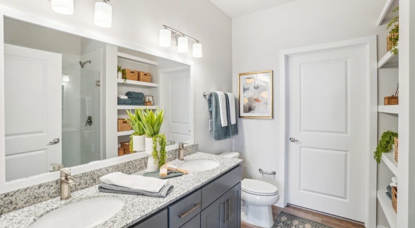 bathroom with a large mirror and two sinks