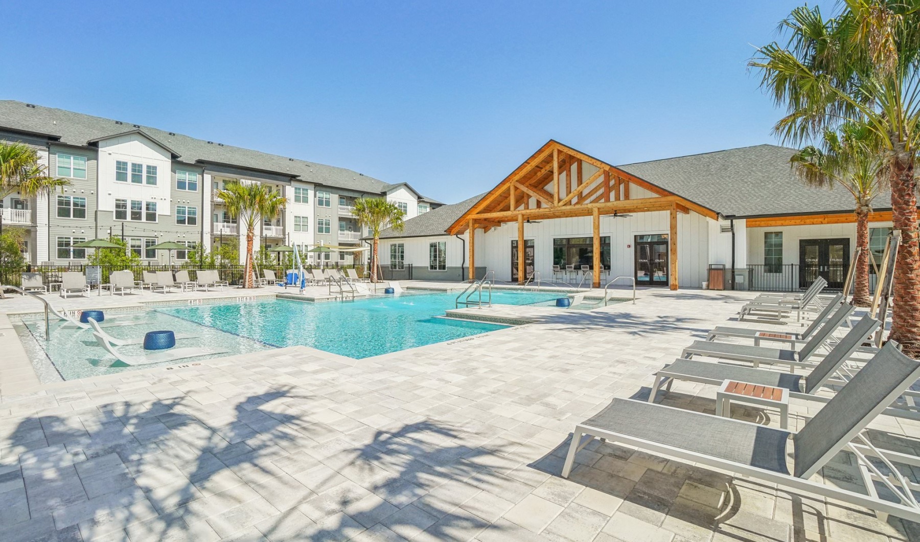 Resort-style swimming pool swimming pool with lounge chairs
